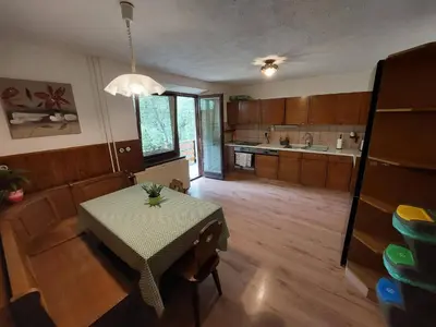 a kitchen with a table and a table and a table and a kitchen at The RiverSide Chill Hostel in Bled