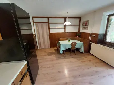 a dining room with a table and chairs in a room at The RiverSide Chill Hostel in Bled