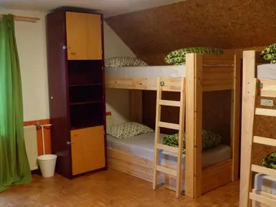 a room with two bunk beds and a ladder at The RiverSide Chill Hostel in Bled