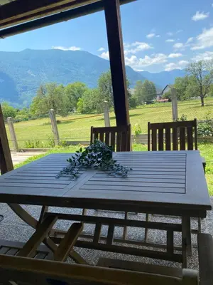 a picnic table with a view of the mountains at Apartma Stres in Bovec