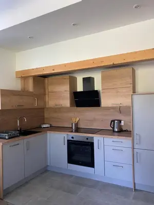 a kitchen with white cabinets and a microwave at Apartma Stres in Bovec