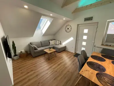 a living room with a couch and a table at Apartma Guide 360 in Bovec