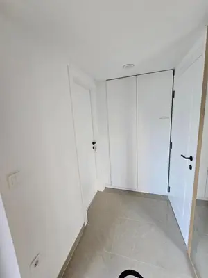 an empty room with white walls and a closet at Delux apartment ARSO in Velenje