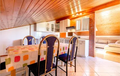 a kitchen with a table and chairs in a room at Stunning Apartment In Divaca With Wifi in Divača