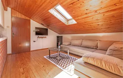 a living room with a couch and a table at Stunning Apartment In Divaca With Wifi in Divača