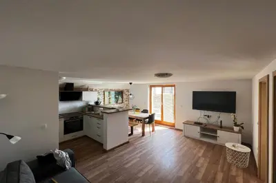a room with a kitchen and a living room at Zemva Stays - Apartma ELA in Zgornje Gorje