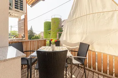 a patio with a table and chairs on a balcony at Turistična kmetija Marovt in Bled