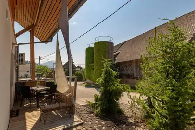 a patio with a table and chairs and plants at Turistična kmetija Marovt in Bled