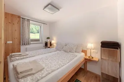 a large bed in a room with a window at Turistična kmetija Marovt in Bled