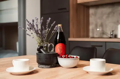 a table with a bottle of wine and a bowl of cherries at Wine paradise Glavinič in Miklavž pri Ormožu