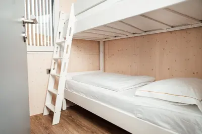 a bunk bed in a small room with a ladder at Wine paradise Glavinič in Miklavž pri Ormožu