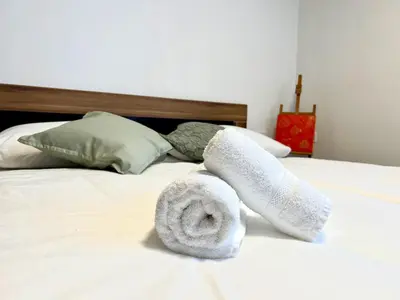 a pair of towels sitting on top of a bed at Apartment ZEN in Zgornje Škofije