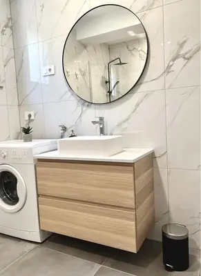 a bathroom with a sink and a washing machine at Apartment ZEN in Zgornje Škofije