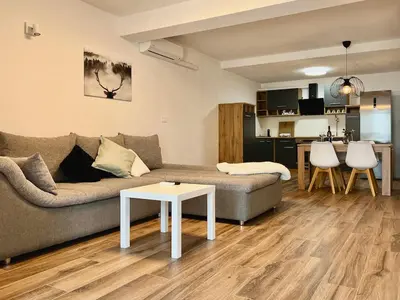 a living room with a couch and a table at Apartment ZEN in Zgornje Škofije