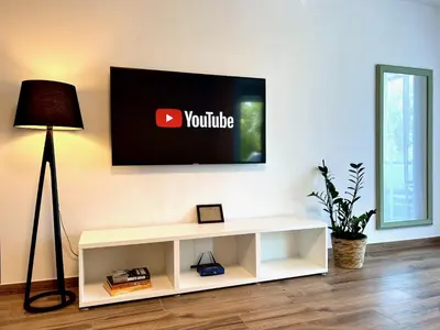 a living room with a television on a wall at Apartment ZEN in Zgornje Škofije