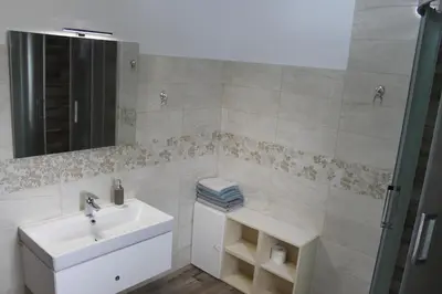 a bathroom with a sink and a mirror at Rooms Jurca in Postojna