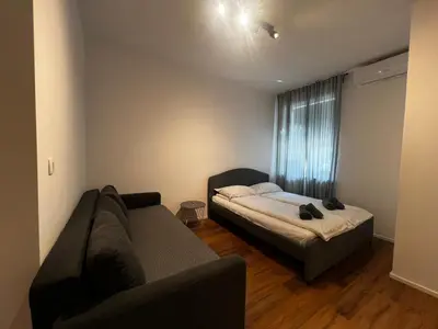 a living room with a couch and a bed at Ljubljana studios in Ljubljana