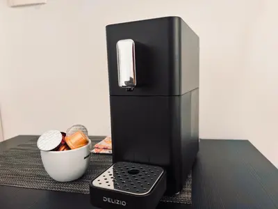 a black refrigerator sitting on top of a table at Ljubljana studios in Ljubljana