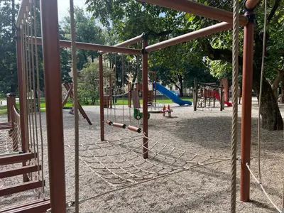 a park with a playground with swings at Ljubljana studios in Ljubljana