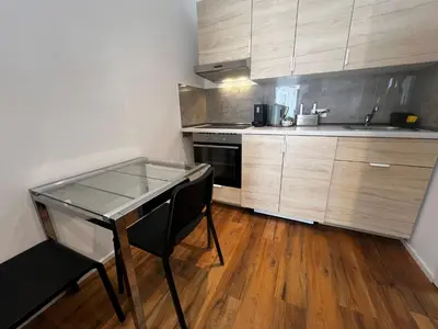 a kitchen with a glass table and a stove at Ljubljana studios in Ljubljana