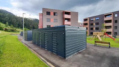 a building with a playground in front of a building at Apartment Ozare in Slovenj Gradec