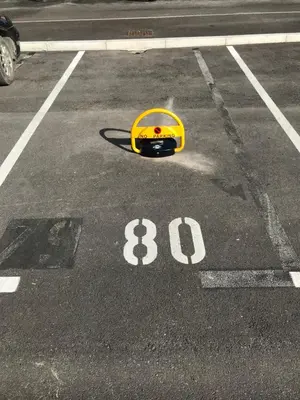 a parking lot with a yellow helmet on the ground at Apartment Ozare in Slovenj Gradec