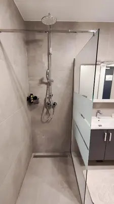 a bathroom with a shower and a sink at Apartment Ozare in Slovenj Gradec