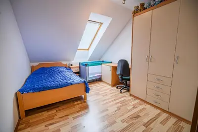 a bedroom with a bed and a desk and a window at Apartment Rimljanček in Leskovec pri Krškem