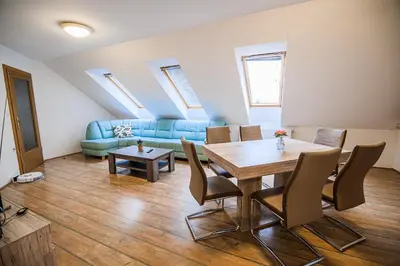 a living room with a table and a couch at Apartment Rimljanček in Leskovec pri Krškem