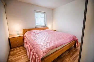 a small bedroom with a bed and a window at Apartment Rimljanček in Leskovec pri Krškem