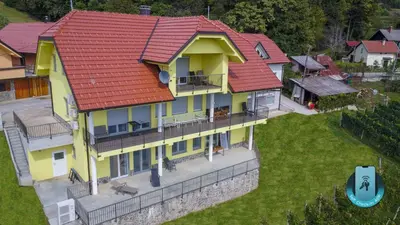 an overhead view of a house with a red roof at Yellow House Grabrovec in Metlika