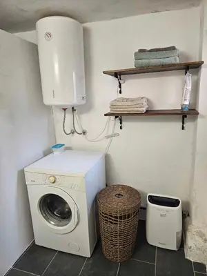 a laundry room with a washing machine and a washer at Apartment Slovan in Škofja Loka