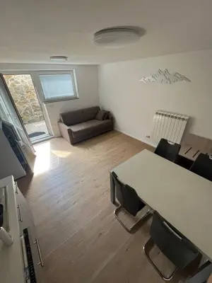 a living room with a table and a couch at Apartma Melinc in Bovec