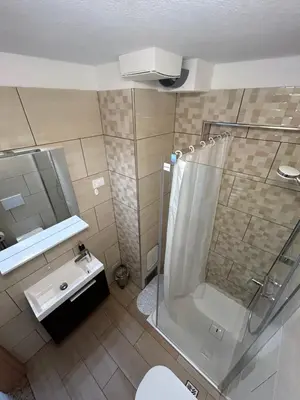 a bathroom with a shower and a sink at Apartma Melinc in Bovec