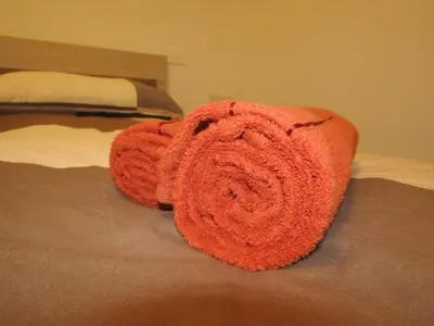 an orange towel is laying on a bed at Apartma Melinc in Bovec