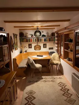 a living room with a table and two chairs at Hiša pod Rogatcem in Luče