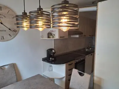a kitchen with a counter and a clock on the wall at Apartment Veninsek in Luče