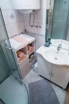 a bathroom with a sink and a shower at Apartment Veninsek in Luče