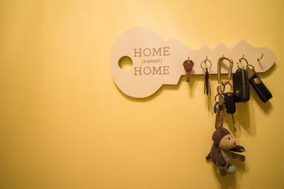 a wall with keys and a home sweet home sign at Apartment Veninsek in Luče