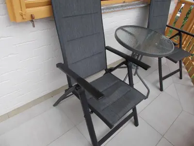 a chair and a table on a balcony at ApartmaVid in Podbočje