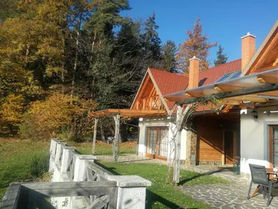a house with a fence and a table and chairs at Apartmaji Pri Handelčanih, Zreče in Zreče