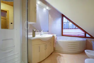 a bathroom with a sink and a tub and a toilet at Apartmaji Pri Handelčanih, Zreče in Zreče