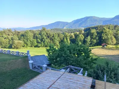 a view of a field with mountains in the background at Apartmaji Pri Handelčanih, Zreče in Zreče