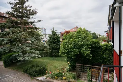 a garden with trees and flowers in a yard at Ljubljana C17 4-Bedroom Private Row House with Garden and Parking in Ljubljana