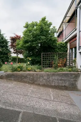 a street next to a building with a fence at Ljubljana C17 4-Bedroom Private Row House with Garden and Parking in Ljubljana
