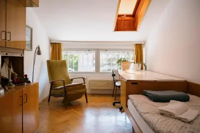 a room with a bed and a desk and a window at Ljubljana C17 4-Bedroom Private Row House with Garden and Parking in Ljubljana