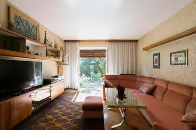 a living room with a couch and a television at Ljubljana C17 4-Bedroom Private Row House with Garden and Parking in Ljubljana