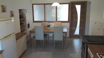 a kitchen and dining room with a table and chairs at Apartma Sterle in Stari Trg pri Ložu