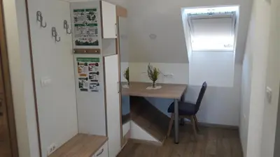 a small room with a desk and a table and a refrigerator at Apartma Sterle in Stari Trg pri Ložu