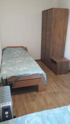 a bedroom with a bed and a dresser in it at Apartma Sterle in Stari Trg pri Ložu